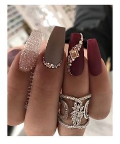 a woman's hand with different colored nail polishes and rings on her fingers