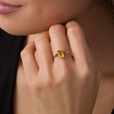 All of love’s precious moments to come sparkle through this gorgeous gemstone and diamond promise ring. Created in precious 10K rose gold, this sophisticated style showcases an 8.0 x 6.0mm emerald-cut golden yellow citrine flanked by trios of alluring black diamonds. Captivating with 1/20 ct. t.w. of diamonds and a bright polished shine, this promise ring makes its presence known at any occasion. Elegant Citrine Birthstone Promise Ring, Anniversary Rose Gold Diamond Ring With Gemstone Accents, Rose Gold Emerald Cut Gemstone Birthstone Ring, Rose Gold Emerald Cut Topaz Ring, 14k Rose Gold Birthstone Ring With Yellow Gold Gemstone, 14k Rose Gold Birthstone Ring With Gemstone, Birthstone Ring In 14k Rose Gold With Gemstone, Rose Gold Emerald Cut Birthstone Ring, Emerald Cut Topaz Ring In Rose Gold