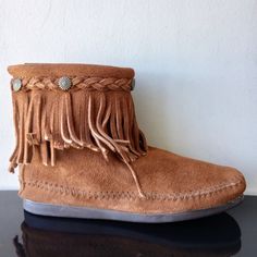 Minnetonka Women's High Top Back Zip Boot In Brown ~ The Essential Suede Boots That Will Rock Your Look. Zip Up Some Of The Most Versatile Boots Around.You Can Wear These Ankle Boots Everywhere And With Everything-From Shorts, To Skirts To Basic Jeans. The Unique Square-Toe Sole, Long Suede Fringe, Subtle Decorative Braid And Metal Conchos Around The Ankles Make These Women’s Boots Stand Apart From The Rest. Plus, They’re Available In A Variety Of Neutral Colors To Match Just About Every Style I Casual Leather Fringe Boots, Adjustable Leather Boots With Round Toe, Western Style Closed Toe Moccasins For Fall, Suede Fringe Boots With Closed Toe, Fall Western Closed Toe Moccasins, Bohemian Leather Slip-on Boots, Bohemian Brown Suede Boots, Casual Fringe Boots With Round Toe, Festival Leather Fringe Boots