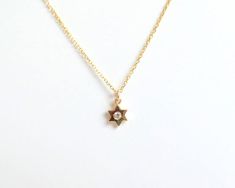 SOLID 14K YELLOW GOLD STAR OF DAVID NECKLACE WITH A DIAMOND. THE STAR IS SOLID 14K YELLOW GOLD AND THE DIAMOND IS NATURAL SI1 CLARITY G COLOR. I MAKE THIS NECKLACE IN VARIOUS LENGTHS AND ALSO IN 14K WHITE AND 14K ROSE GOLD. PLEASE SPECIFY THE LENGTH AND COLOR GOLD WHEN ORDERING. FREE SHIPPINGWITHIN THE USA METAL: YELLOW GOLD 14K 585 STONES: NATURAL DIAMOND 0.03 CT SI1 CLARITY G COLOR STYLE: STAR OF DAVID NECKLACE PURITY: 14K SIZE: 5.5 mm AS IT IS WITH THIS ITEM ALL MY PIECES ARE HAND MADE. AND I Star-shaped Yellow Gold Birthstone Necklace, Yellow Gold Star Shaped Necklace With Birthstone, Yellow Gold Star Necklace With Birthstone, Gold Star Of David Necklace With Birthstone, Gold Star-shaped Birthstone Necklace, Gold Star Necklace With Birthstone, Star Of David Necklace, Necklace With Diamond, Star Of David Pendant