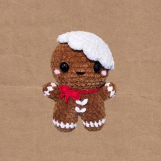 a small brown teddy bear wearing a white hat and red bow tie on it's head