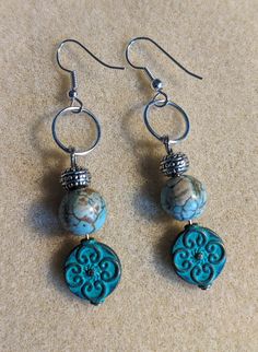 the earrings are made with turquoise and white beads