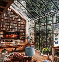 a living room filled with lots of furniture and bookshelves next to a fire place