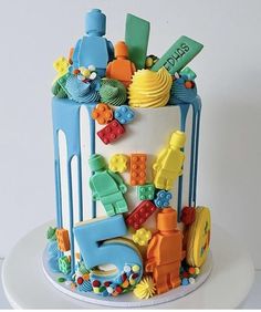 a birthday cake decorated with legos and toys