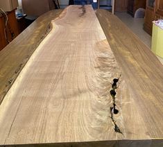 a wooden table in the middle of a kitchen