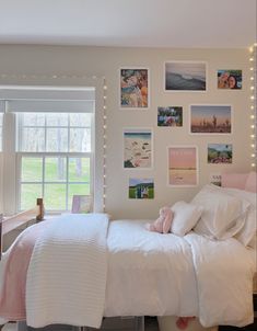 a bedroom with pictures on the wall above the bed and below the bed is a desk