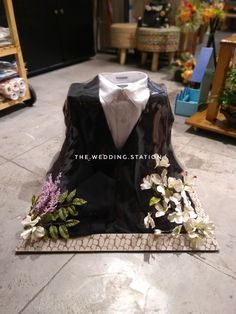 the wedding station is decorated with flowers and tuxedo