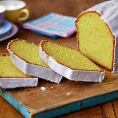 slices of cake sitting on top of a wooden cutting board