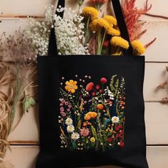 Elevate your style with this Black Floral Pattern Print Tote Bag! Crafted from cotton materials, this botanical print carry bag is perfect for daily use or as a stylish purse. Thoughtfully designed, it's the ideal gift for her on birthdays or Christmas. Add a touch of nature to her wardrobe today! This 100% cotton bag comes in one size - 15" x 16"- perfect for everyday wear. While the canvas material will show off your designs in great colors, it's durable and will last for years. The bag featur Rectangular Cotton Floral Print Shoulder Bag, Rectangular Cotton Shoulder Bag With Floral Print, Black Bags With Floral Embroidery For Spring, Spring Black Cotton Shoulder Bag, Everyday Black Bag With Floral Print, Daily Use Cotton Canvas Bag With Floral Embroidery, Casual Floral Print Shoulder Bag Perfect For Gift, Rectangular Floral Print Canvas Bag, Floral Print Rectangular Canvas Bag