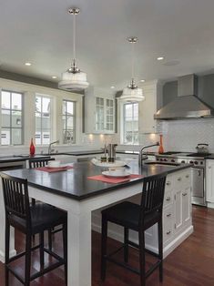 a large kitchen with an island in the middle