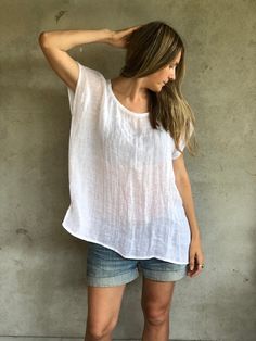 "This is a lovely, light weight gauze linen top, that is meant to be loose and comfortable. Perfect for hot days when all you want to feel is a soft breeze against your skin. Made from 100% pure linen gauze. It is somewhat see through and might require a slip underneath. Each piece is individually cut, sawn and pre-washed. See standard sizing below. We really love making various sizes - from petit to plus size and more. For the best fitting of this shirt please let us know the following measurem White Relaxed Fit Breezy Tops, Spring Cotton Gauze Tops With Relaxed Fit, Spring Cotton Gauze Short Sleeve Tops, Spring Cotton Gauze Flowy Tops, Bohemian Linen Tops With Relaxed Fit, Spring Flowy Cotton Gauze Tops, Spring Relaxed Fit Cotton Gauze Tops, Spring Short Sleeve Cotton Gauze Tops, Relaxed Fit Cotton Gauze Tops For Spring