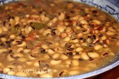 a bowl filled with beans and vegetables on top of a table