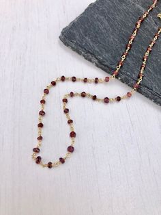 Garnet Necklace, Garnet Beaded Necklace, January Birthstone, Dainty Garnet Necklace, Red Choker Necklace, Simple Gold Necklace, Gift for her Beaded red garnet rosary style necklace wire wrapped in 14k gold filled or sterling silver. Rondelles are 3mm in size. Necklace closes with lobster clasp in the finish of your choice. About This Necklace: - Stone: Garnet - Birthstone Month: January - Garnet Properties: Friendship, Love and Guidance - Stone Size: 3mm - Necklace Length: Choice of 16 or 18 inc Garnet Beaded Necklaces As Gift, Garnet Bead Necklaces For Gifts, Garnet Necklaces With Faceted Beads For Gifts, Garnet Round Bead Necklace For Gift, Garnet Round Beads Necklace For Gift, Faceted Beads Chain Necklace As Gift, Gift Chain Necklace With Faceted Beads, Red Beaded Chain Necklace Gift, Red Beaded Chain Necklace For Gift