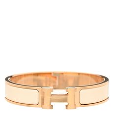 This is an authentic HERMES Enamel Narrow Clic Clac H Bracelet PM in Creme. This is a chic bracelet from Hermes that is classic yet very modern. It has a thin band of rose gold with a hinge on one side and opens with a swivel Hermes "H" on the prominent side. Around the band is a strip of gorgeous white enamel inlay. Hermes Ring, H Bracelet, Hermes Bracelet, Chic Bracelet, Hermes Bags, White Enamel, Rose Gold, Bracelet, Band