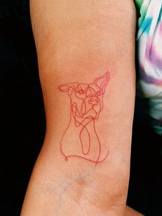 a woman's arm with a red line drawing of a dog on the side