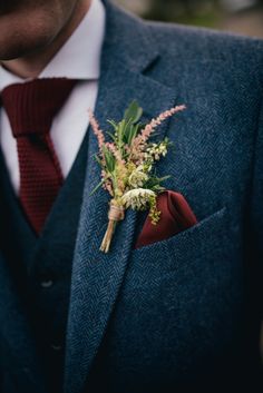 a man in a suit with a boutonniere on his lapel