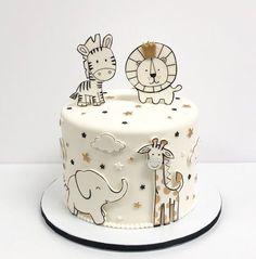 a white cake decorated with animals and stars