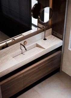 a bathroom with a sink and mirror in it