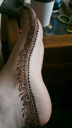 the foot is decorated with henna on it's side and has an intricate design