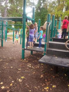 children are playing on the playground equipment