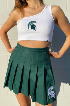 The Senior Top for Michigan State. Classic ribbed-knit tank top with a single shoulder strap. Soft ribbed knit cropped to the waist in a stretch-fit bodycon fit. Comes in white. Style it your way! Product details and fit: Bra friendly One Shoulder Cropped Ribbed fabric Slim fitting Stretchy fabric Option to add embroidered logo About the model: Size: S Height: 5’6” Made to order. Made for you ♡ P.S. We'd love to see you repping this style! Don't forget to tag us to be featured *All MTO orders ar Michigan State Tailgate, Trendy College Outfits, Tailgate Outfits, Tailgate Outfit, Pleated Tennis Skirt, Tennis Skirts, Trendy Skirts, Athletic Looks, Michigan State