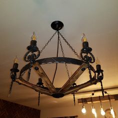 a chandelier made out of wooden planks hanging from the ceiling