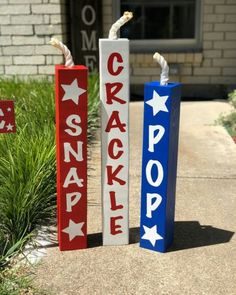 two red, white and blue wooden signs with the words cracker pop on them