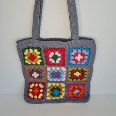 a crocheted granny bag hanging on a wall