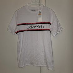 Nwt Calvin Klein Brilliant White Striped Logo Tee Calvin Klein White Logo Print T-shirt, Sporty Calvin Klein Tops With Logo Print, White Calvin Klein Crew Neck T-shirt, Calvin Klein White Crew Neck T-shirt, Calvin Klein White Short Sleeve Shirt, Calvin Klein White Short Sleeve Top, White Short Sleeve Calvin Klein Shirt, White Calvin Klein Casual Shirt, Calvin Klein White Relaxed Fit T-shirt