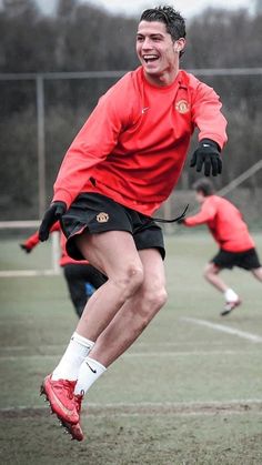 a man in red shirt and black shorts playing soccer