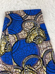 This blue with a touch of shimmering gold African Fabric is high quality African print made from 100% cotton and it's 45 inches wide. It is used for making African Clothing, African quilts, & For Home decoration. FYI: Print is Double sided. The listing is for 1, 6 yards and Headwrap Each piece of fabric measures:  36in by 45in for 1 yard 216in by 45in for 6 yards 70in by 22in for Head wrap If you purchase more than one yard, you will receive one continuous piece. *If you require more than what I have listed, feel free to send me email. CARE INSTRUCTIONS: *DO NOT BLEACH *Hand wash with cold water and mild soap or Dry clean *Press with hot iron for a crispy look. Color may be different due to your monitor Blue Ankara Fabric With Traditional Patterns, Traditional Blue Batik Print Fabric, Blue Printed Ankara Fabric, Blue Cotton Fabric With Traditional Patterns, Blue Ankara Fabric With Unique Pattern, Traditional Blue Fabric With Unique Pattern, Blue And Gold Fabric, African Headwrap, African Quilts