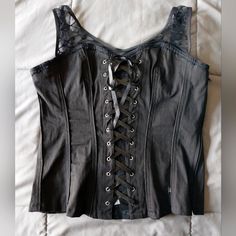 I Bought This Brand New At Least Fifteen Years Ago (Maybe More!) And Never Wore It. It Is New With Tags Still Attached. It's A Black Corset Style Top. It Doesn't Have Any Boning In It And Won't Reduce Your Waist Size. The Fabric Is A Solid Black Fabric With Skull Lace Straps. It Has A Black Zipper Up The Side And Laces Up The Front With Satin Ribbon. It's A Size Xxl. The Chest Measures About 18.5", The Length Is About 21", The Waist Is About 16", And About 18" At The Bottom. Those Measurements W Black Edgy Corset For Concert, Black Sleeveless Y2k Corset, Black Y2k Deadstock Tops, Corset Shirt Outfit, Y2k Corset Top, Y2k Corset, Goth Princess, Style Bundle, Corset Shirt