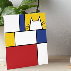 a white cat with red, yellow and blue squares on it's face art board print