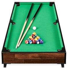 a pool table with cues and balls on it