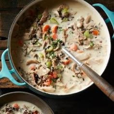 two pans filled with soup on top of a wooden table