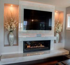 a large flat screen tv mounted above a fireplace