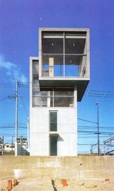 a tall white building sitting on the side of a road