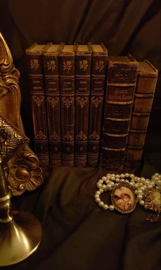 antique books and pearls are on the table