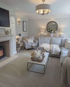 a living room filled with furniture and a flat screen tv mounted on the wall above a fire place