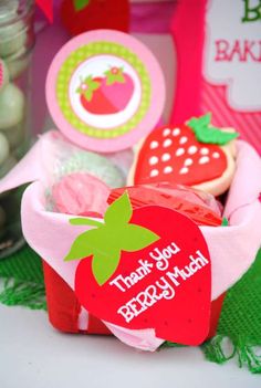 an assortment of cookies and candy in a cup with thank you broccoli stickers