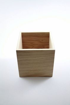 a small wooden box sitting on top of a white table