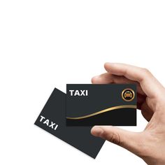 a hand holding a black and gold business card with the word taxi printed on it