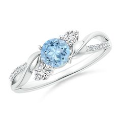 an oval blue topazte and diamond ring with two diamonds on the shoulders, set in white gold