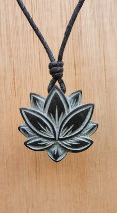 Lotus flower yoga symbol necklace pendant. It's hand carved by myself. This piece is carved on the both sides with details. It's made from stone called green granite, it's similar to soapstone, but more harder and durable then the soapstone.  The size of the pendant is approxmatly 2.8cm x 2.8cm ( 1.1inches x1.1inches ). It comes with adjustable black waxed cotton cord. Not only are these pendants a beautiful thing to wear as part of your jewellery collection, but they are also very pleasing to t Yoga Symbol, Green Granite, Hand Carved Stone, Symbol Necklace, By Myself, Crown Chakra, Stone Carving, Flower Charm, Cotton Cord