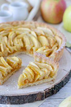 an apple pie is cut into slices on a plate