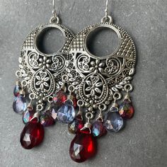 I have used two different kinds of mystic stones to show off these fun filigree silver alloy chandeliers. The blue stones are mystic quartz and the red ones are mystic rhodolite garnets. Please choose your choice of sterling silver earwires. The approximate length is 2.5". Your jewelry will arrive beautifully giftboxed. Red Bohemian Nickel-free Chandelier Earrings, Red Bohemian Chandelier Earrings Nickel-free, Bohemian Red Nickel-free Chandelier Earrings, Jeweled Dangle Chandelier Earrings, Silver Jeweled Chandelier Earrings, Bohemian Jeweled Chandelier Earrings As Gift, Red Bohemian Chandelier Earrings For Pierced Ears, Red Bohemian Chandelier Earrings, Bohemian Red Chandelier Earrings