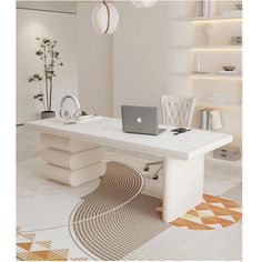 a white desk with a laptop on it in a room that has an orange and white rug