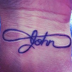 a wrist tattoo with the word john written in cursive writing on it's side