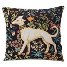 an embroidered pillow with a dog on it's side and flowers in the background