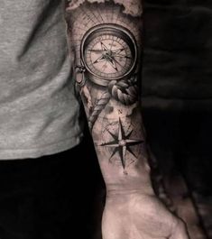 a man with a compass tattoo on his arm